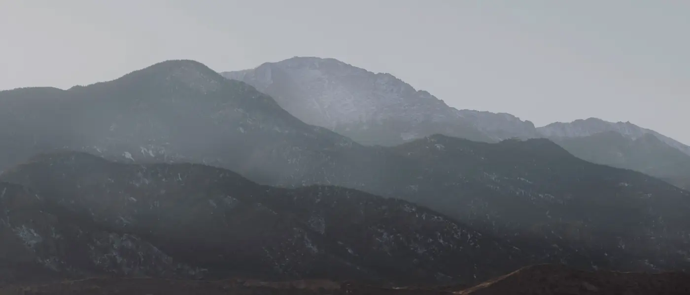 Pikes Peak in winter haze above the foothills